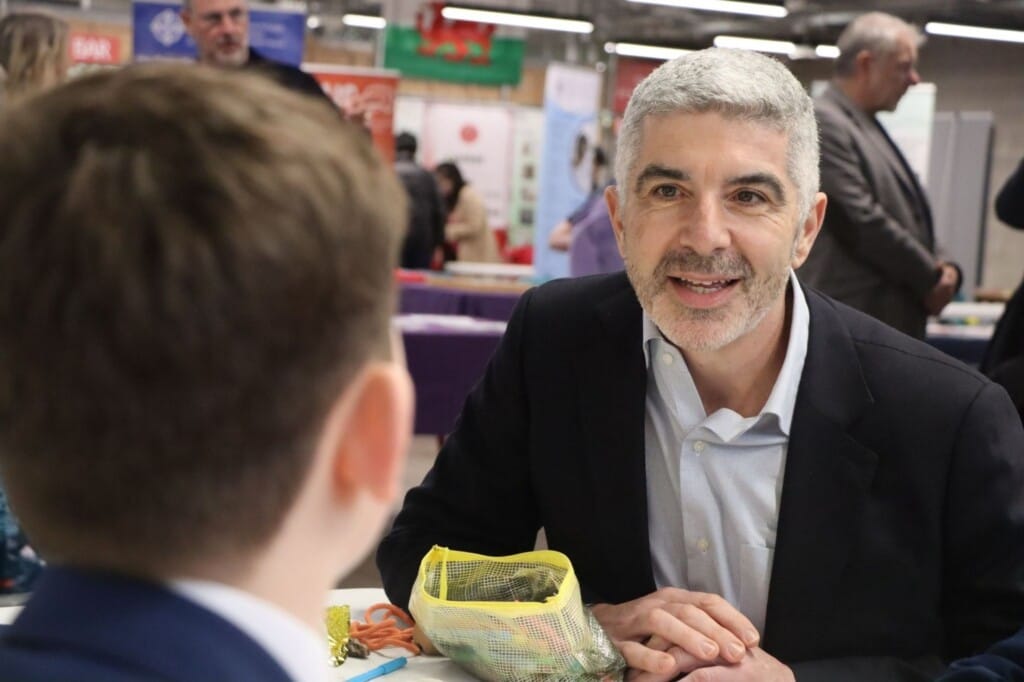 Derek Walker talking to a pupil